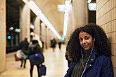 Smiling woman standing at train station