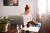 Woman using laptop at home