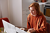 Woman using laptop at home