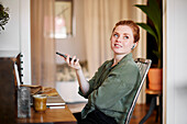 Woman at home talking via cell phone