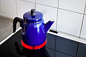 Blue kettle on electric hob