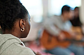 Teenage girl attending guitar lesson