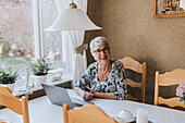 Senior woman sitting at dining table