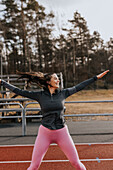 Woman exercising at running track