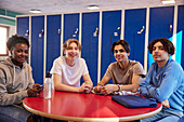 Teenagers sitting in locker room