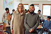 Portrait of teachers with students in background