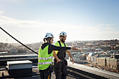 Workers standing on roof