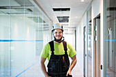Smiling worker standing at corridor