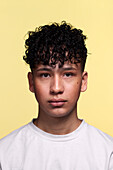 Portrait of boy against yellow background