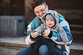 Smiling mother sitting with baby