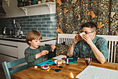 Mother with son sitting at table