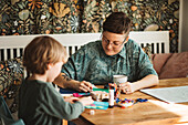 Mother with son doing craft