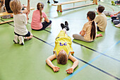 Children having class in school gym