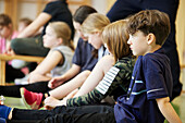 Children having class in school gym