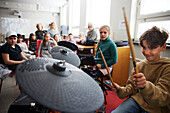Children playing drums at school