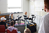 Children playing drums at school