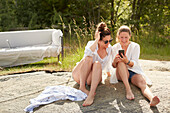 Smiling female friends using cell phone