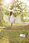 Woman relaxing in hammock