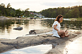 Woman using laptop at lake