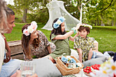 Family wearing flower wreaths at picnic