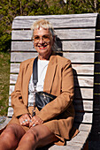 Mature woman relaxing on sun lounger