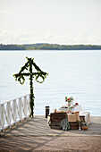 Table with midsummer meal at lake
