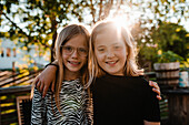 Girls embracing in garden