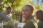 Smiling woman at table in garden