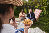 Woman holding plate with pastries