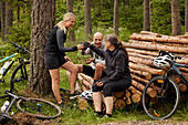 Cyclists drinking tea in forest