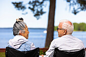 Senior couple relaxing by sea