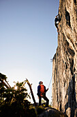 Male rock climber belaying