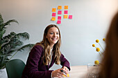 Smiling businesswoman sitting in office