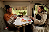 Friends playing cards in camper van