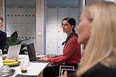 Smiling businesswoman looking away