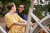 Female couple embracing and talking outdoors