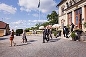 Business people leaving elegant restaurant