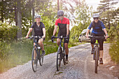 Smiling friends cycling together