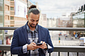 Smiling man using cell phone