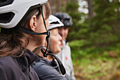 People in bicycle helmets in forest