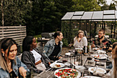 Friends having meal in garden