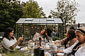 Friends having meal in garden