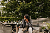 Smiling woman using phone in garden