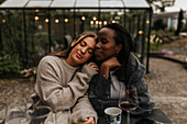 Female friends sitting in garden