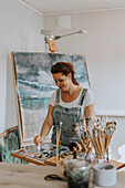 Artist painting in studio