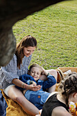 Mother and daughter having picnic