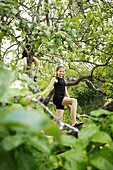 Girl climbing tree