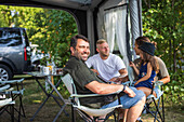 People relaxing at camping site