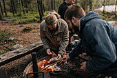 Couple preparing food on barbecue