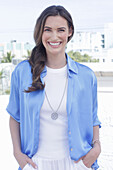 Young woman in white t-shirt and blue long blouse